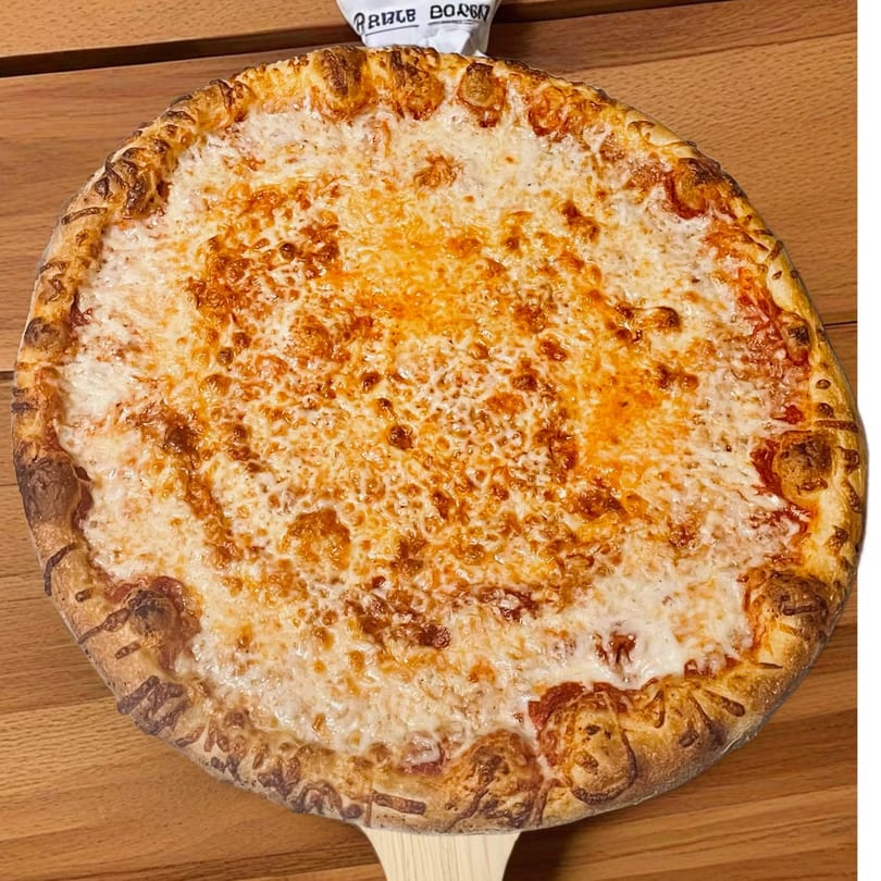 A TopCrust Jupiter Kitchen cheese pizza with a golden crust, served on a wooden paddle.