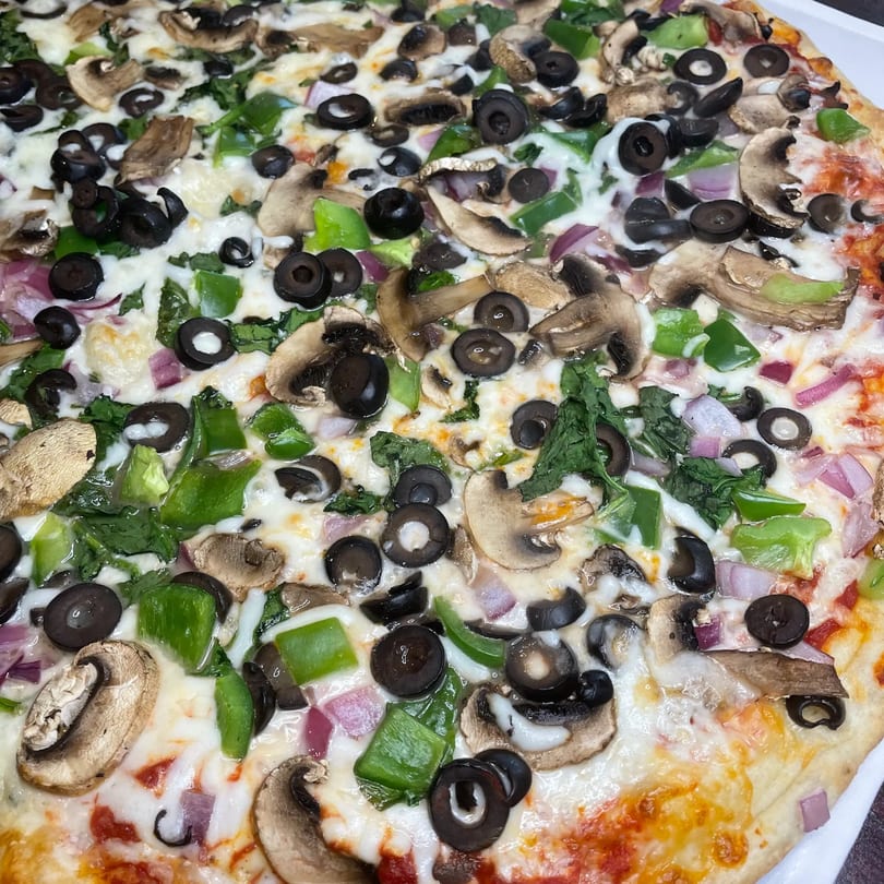 TopCrust Jupiter Kitchen's pizza with mushrooms, black olives, green peppers, and red onions.
